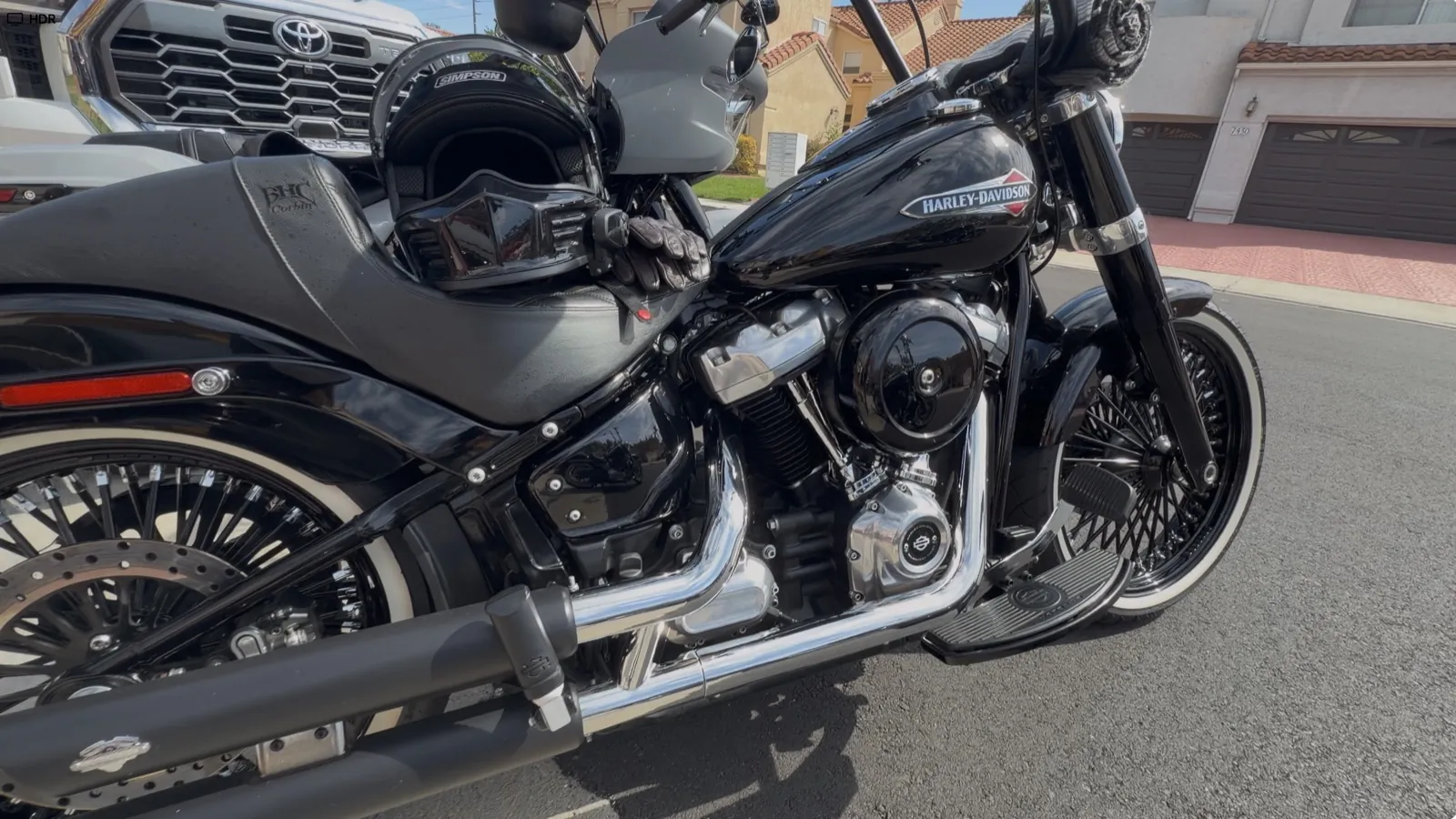 Full-face helmet resting on the seat of a parked Harley-Davidson