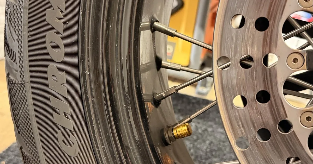 Avon Cobra Chrome rear tire, spoked wheel, and drilled brake rotor on a Harley Night Train