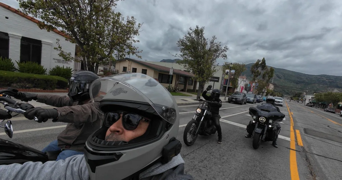 Riding through town with the crew, one rider with an arm raised
