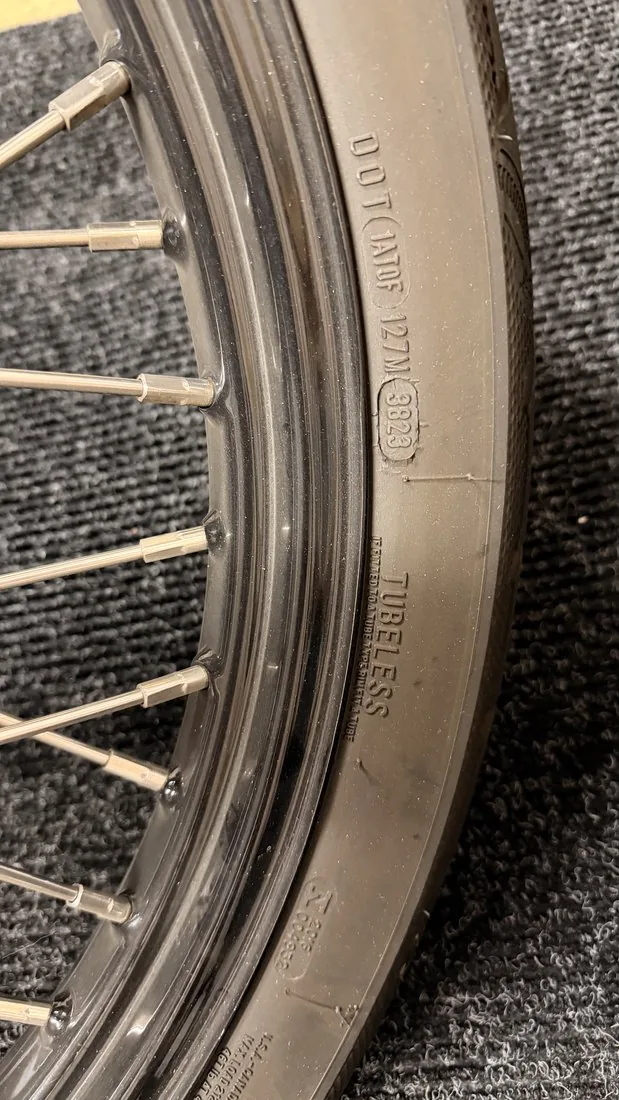 DOT date code 3823 on a motorcycle tire sidewall, meaning the 38th week of 2023