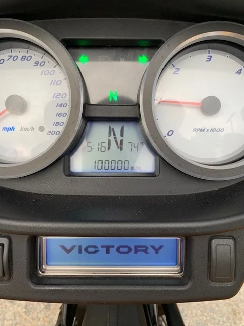 Motorcycle dash showing 100,000 miles on the odometer