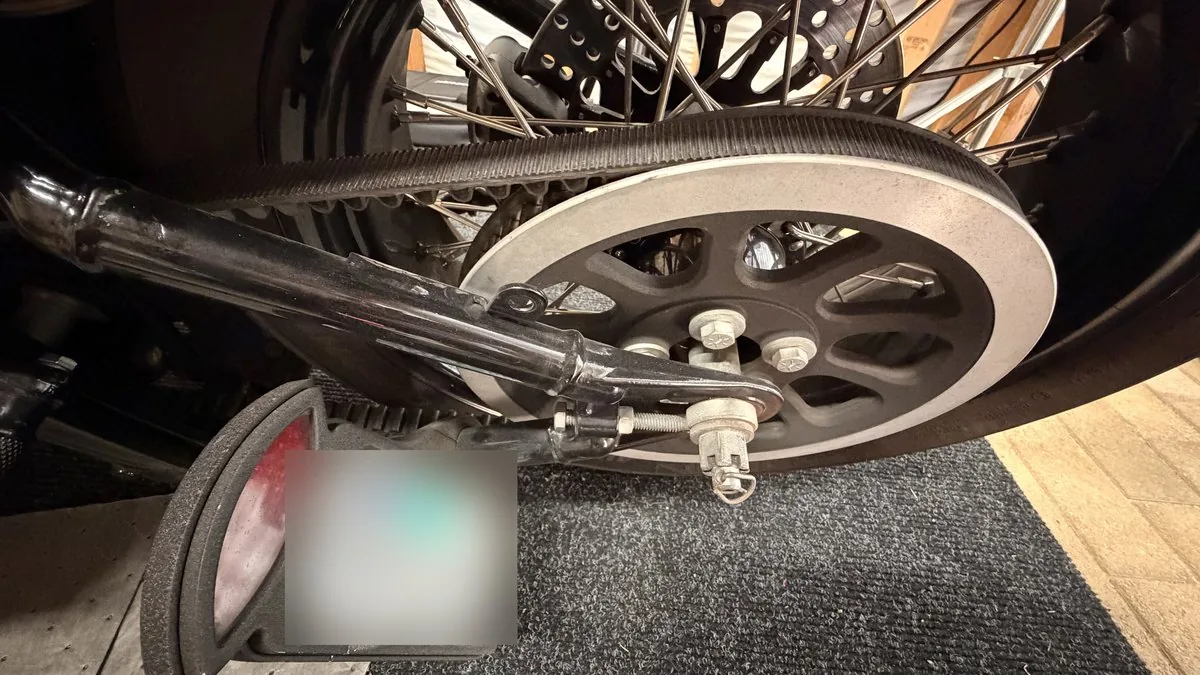 Harley drive belt and rear pulley from the side, with the axle adjuster that sets belt tension